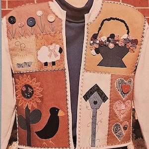 May include: A white quilted vest with a variety of appliques, including a sunflower, a bird, a birdhouse, a basket of flowers, a sheep, and hearts. The vest has a zipper closure and a brown collar.