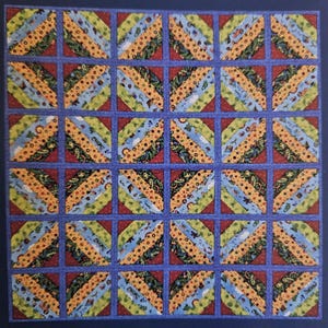 May include: A quilt with a repeating pattern of diagonal stripes in blue, yellow, green, and red. The quilt is made up of 36 squares.