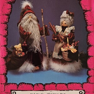 May include: A vintage craft pattern for a Christmas Past Hob Knobs project. The pattern features a Santa and a woman holding a basket of goodies. The pattern is printed on a pink background with a white border. The text on the pattern reads "Kalico Kastle Original Patterns", "Hob Knobs - Christmas Past", and "presented by Jan & Judy".