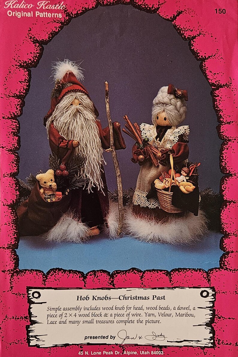 May include: A vintage craft pattern for a Christmas Past Hob Knobs project. The pattern features a Santa and a woman holding a basket of goodies. The pattern is printed on a pink background with a white border. The text on the pattern reads "Kalico Kastle Original Patterns", "Hob Knobs - Christmas Past", and "presented by Jan & Judy".