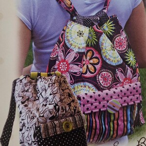 May include: Two fabric backpacks with different patterns. The backpack on the left has a black and white pattern of shoes. The backpack on the right has a pink, black, and green floral pattern. Both backpacks have a pocket on the front with a button.