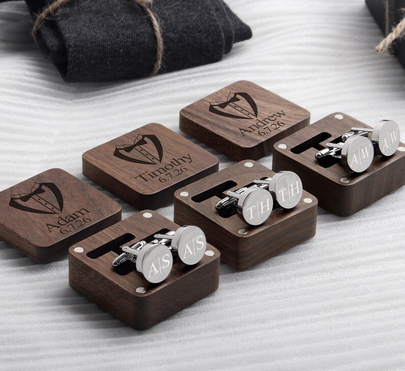 May include: Five wooden boxes with engraved names and dates, each containing a pair of silver cufflinks. The cufflinks are engraved with initials.