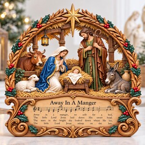 May include: A decorative nativity scene featuring Mary, Joseph, and the infant Jesus in a manger, surrounded by a cow, a donkey, and a lamb. The frame is adorned with holly and a star, displaying the text Away In A Manger with musical notes.