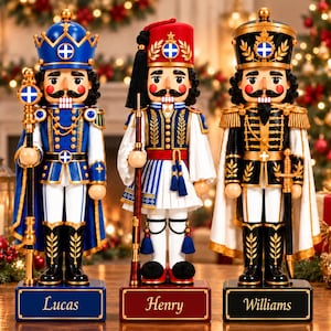 May include: Three nutcracker figures standing on rectangular bases labelled Lucas, Henry, and Williams. The left figure wears a blue crown and uniform, the centre wears a red fez and white kilt, and the right wears a black military uniform.