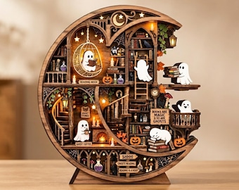 May include: A crescent moon-shaped wooden diorama featuring a multi-level library with miniature ghosts, bookshelves, a fireplace, and hanging lanterns. The structure includes text signs reading "READING NOOK," "GHOST STORIES," "GHOST COFFEE," "BOOKS ARE MAGIC & SO ARE GHOSTS," "SHHH!," "GHOSTS READING," and "READING IS A MOOD."