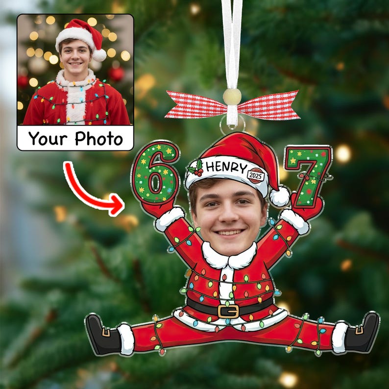 May include: A personalized Christmas ornament featuring a photo of a person in a Santa hat and suit. The ornament is shaped like a person doing a split, holding the numbers "6" and "7". The name "Henry" is on the Santa hat.