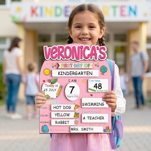 May include: A pink first day of kindergarten sign with the name "Veronica's" at the top. The sign includes the date, age, height (48 inches), favorite food (hot dog), color (yellow), and animal (rabbit).