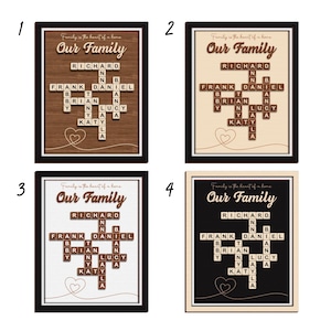 May include: Four framed prints with a wood-like background featuring a scrabble tile word art design that says "Our Family" with the names Richard, Frank, Daniel, Brian, Lucy, and Katy spelled out in the tiles.