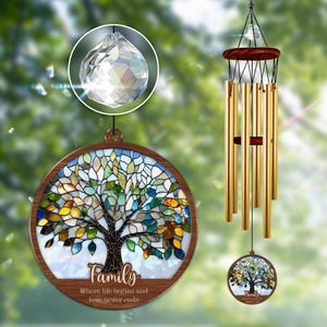 May include: A stained glass wind chime with a tree design and the words "Family, where life begins and love never ends". The chime has a crystal prism hanging from the top and is made of gold-colored metal tubes.