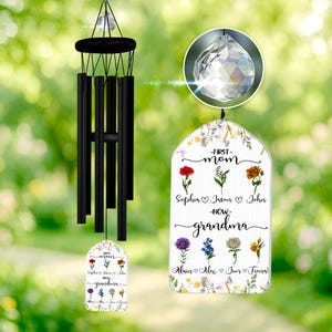 May include: A black wind chime with a white tag that reads "First Mom - Now Grandma" with floral accents and names of children. The tag is decorated with colorful flowers and butterflies.