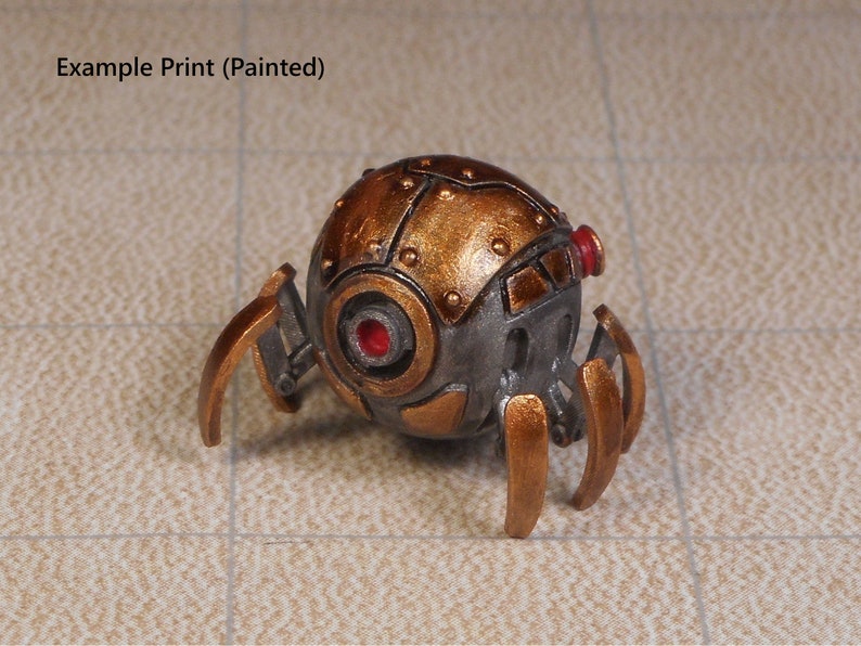 May include: A small, metallic, steampunk-style robot with a spherical body and six spindly legs. The body is painted in a copper color with silver accents and has a red eye. The legs are painted in a gold color.