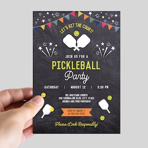 May include: A black and white invitation with colorful flags at the top. The text reads "Let's hit the court! Join us for a Pickleball Party. Saturday, August 12, 3:30 PM. Del Mar Park Courts, 290 Tourmaline Blvd, City, State. Drinks and food provided. RSVP by August 1 at 582-834-2732. Please Dink Responsibly!"