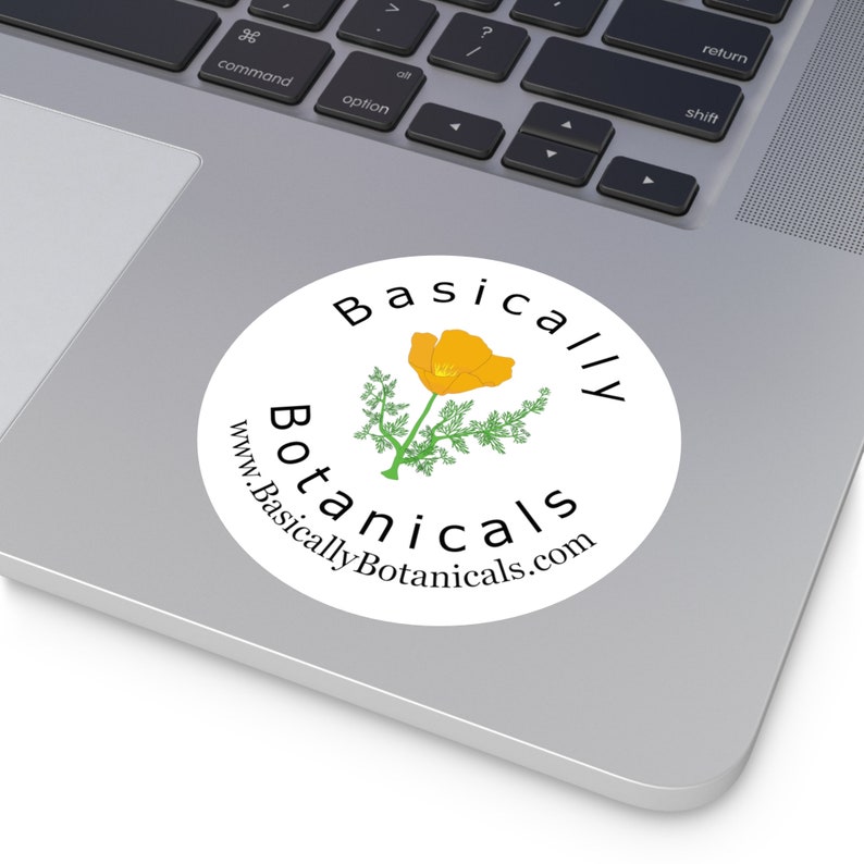 May include: A white circle sticker with the text "Basically Botanicals" and the website address "www.BasicallyBotanicals.com" in black text. A yellow California poppy flower with green leaves is in the center of the sticker.