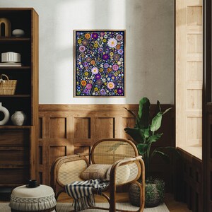 May include: A rectangular framed wall art print featuring a dense, vibrant botanical illustration of various flowers in shades of purple, pink, orange, yellow, and white against a dark navy blue background, displayed in a simple wooden frame.