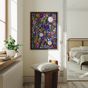 May include: A rectangular wall art print featuring a dense, colorful pattern of various flowers including daisies, zinnias, and small blossoms in shades of purple, pink, yellow, and orange set against a dark navy blue background in a wood frame.