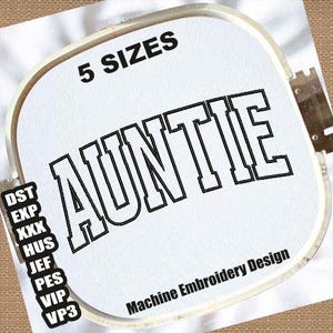 May include: A white embroidery hoop with black text that reads "5 SIZES" and "AUNTIE" in a large, bold font. The text "Machine Embroidery Design" is also visible in black at the bottom of the hoop.