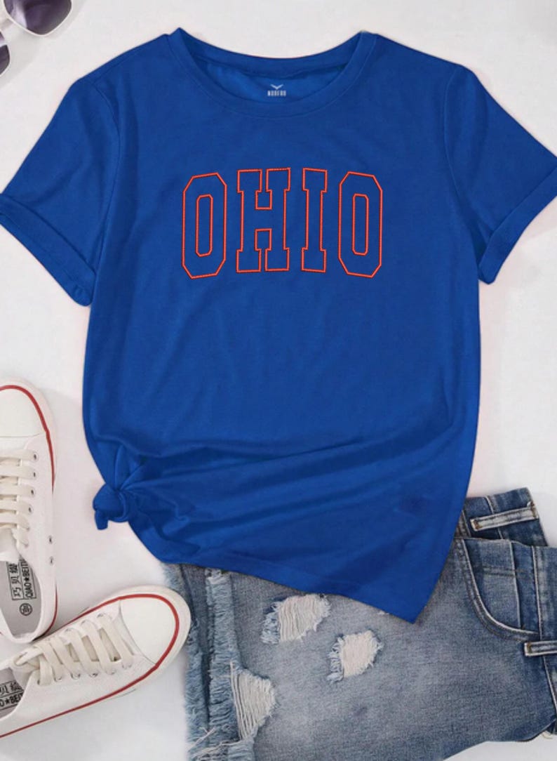 May include: A royal blue t-shirt with a red outline of the word "OHIO" printed on the front.