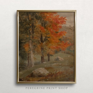 Puede incluir: Una pintura enmarcada que representa una escena de bosque con &aacute;rboles en tonos verdes, naranjas y rojos. Los &aacute;rboles est&aacute;n en primer plano, con una colina ondulada en el fondo. La pintura est&aacute; en un marco dorado.