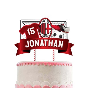 May include: Red and black football cake topper with a football, jersey, and a football goal. The topper has a banner with the text "JONATHAN" and the number "15".