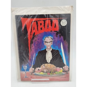 May include: A comic book titled Taboo featuring a horror illustration of a pale figure in a black suit with a white cravat holding a fork and knife over a platter of food. The background is dark with red text and a small circular logo in the corner.