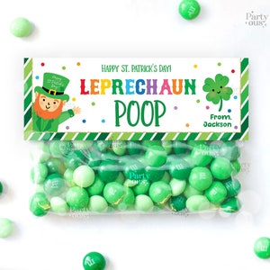 May include: A green and white striped treat bag with a label that says "Happy St. Patrick's Day! Leprechaun Poop" with a cartoon leprechaun and a four-leaf clover. The bag is filled with green M&Ms.