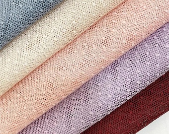 May include: A collection of five folded layers of fine mesh fabric arranged diagonally. The colors include dark gray, cream, light peach, soft lavender, and deep burgundy. Each layer features a delicate, uniform dotted texture throughout.
