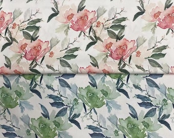 May include: A fabric featuring a watercolor floral pattern. The top section displays pink flowers with green leaves on a white background. The bottom section shows the same floral design in shades of green and blue on a white background.