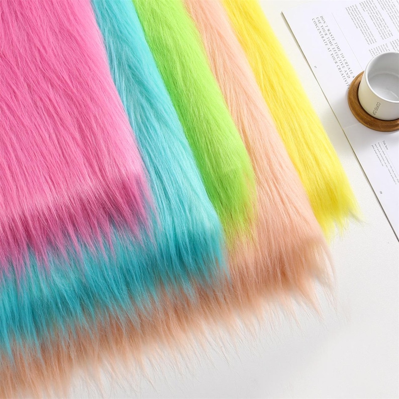 May include: Five strips of long-pile faux fur fabric arranged side-by-side in vibrant colors including hot pink, turquoise, lime green, peach, and bright yellow. The texture is shaggy and soft, with each strip displaying a consistent, dense pile.
