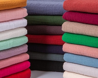May include: Stacks of colorful fabric in various shades, including red, pink, green, and blue. The fabric appears to be a textured weave, possibly linen or cotton, and is neatly folded. The image showcases a variety of colors and textures.