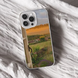 iPhone 15 14 13 12 11 clear case with Nature and Cottage core design on it, there are total of five options to choose from. Aesthetic flowers, river, plains, book lover artwork are depicted.