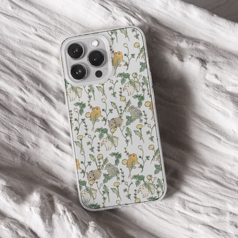 iPhone 15 14 13 12 11 clear case with Cute Bunny design on it, there are total of five phone cover options to choose from. Nature core rabbit, cottage core flower pattern, farm life, carrot, animal cover artwork are depicted.
