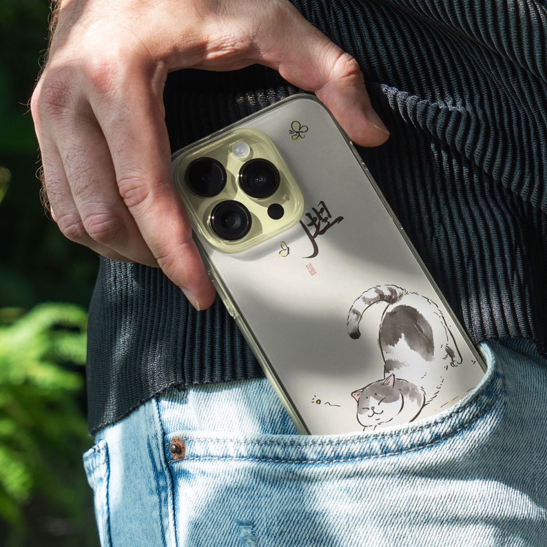 iPhone 15 Pro Max 14 Plus 13 12 11 clear case with Aesthetic cat design on it, there are total of five phone cover options to choose from. Funny kitty, cute pet animal, feline, flowers, japanese style, adorable artwork cover are depicted.