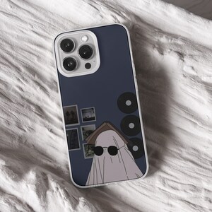 iPhone 15 Pro Max 14 Plus13 12 11 clear case with Ghost Halloween design on it, there are total of five options to choose from. Aesthetic spooky Halloween, flowers red and violet, camping ghosts, horror and goth artworks are depicted.