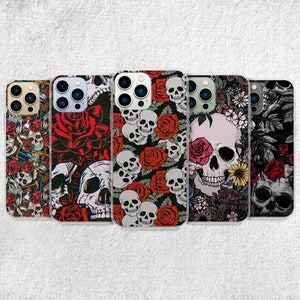May include: Five different phone cases with a skull and rose pattern. The cases are all clear and show the phone's design through the case. The cases have a black background with red roses and white skulls.