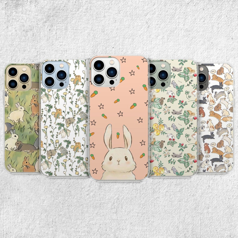 iPhone 15 14 13 12 11 clear case with Cute Bunny design on it, there are total of five phone cover options to choose from. Nature core rabbit, cottage core flower pattern, farm life, carrot, animal cover artwork are depicted.