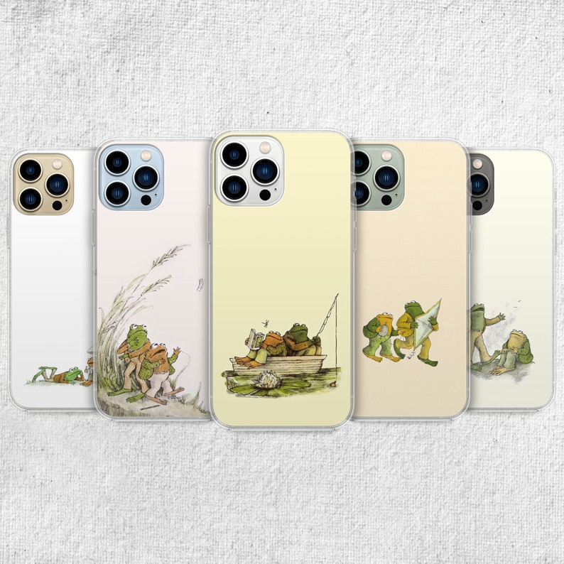 iPhone 15 Pro Max 14 Plus 13 12 11 clear case with Frog and Toad Aesthetic design on it, there are total of five phone cover options to choose from. Green cottage core, nature core, old children book, animals, pastel cover artworks are depcited.