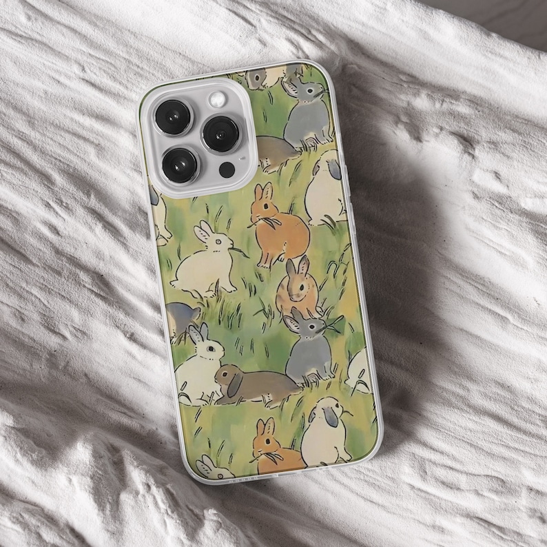 iPhone 15 14 13 12 11 clear case with Cute Bunny design on it, there are total of five phone cover options to choose from. Nature core rabbit, cottage core flower pattern, farm life, carrot, animal cover artwork are depicted.