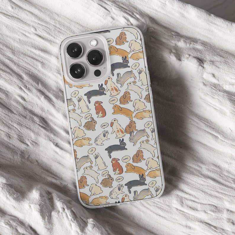 iPhone 15 14 13 12 11 clear case with Cute Bunny design on it, there are total of five phone cover options to choose from. Nature core rabbit, cottage core flower pattern, farm life, carrot, animal cover artwork are depicted.