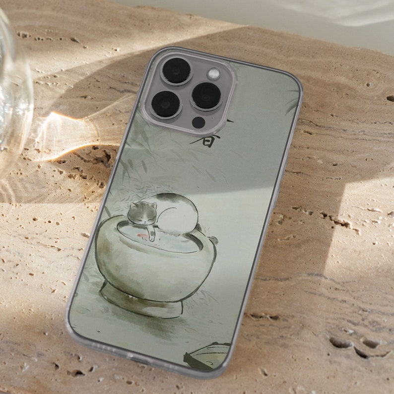 iPhone 15 Pro Max 14 Plus 13 12 11 clear case with Aesthetic cat design on it, there are total of five phone cover options to choose from. Funny kitty, cute pet animal, feline, flowers, japanese style, adorable artwork cover are depicted.