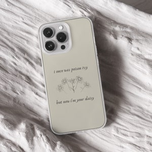 iPhone 15 Pro Max 14 Plus 13 12 11 clear case with Taylor Swift aesthetic design on it, there are total of five phone cover options to choose from. Music Song lyrics, Midnights, Folklore, pastel, evermore, 1989 cover artworks are depicted.