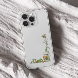 iPhone 15 Pro Max 14 Plus 13 12 11 clear case with Frog and Toad Aesthetic design on it, there are total of five phone cover options to choose from. Green cottage core, nature core, old children book, animals, pastel cover artworks are depcited.