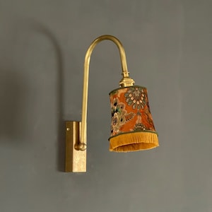 Brass wall sconce with lampshade