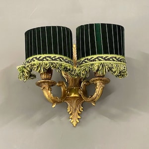 Small pleated green lampshades on clip-on for sconces.