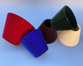 pleated lampshades in different colors and sizes, green lampshade, burgundy lampshade, brown lampshade, beige lampshade, blue lampshade.