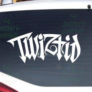 May include: White vinyl decal featuring the word "Twiztid" in a stylized, gothic font. The decal is displayed on a car window. The Jordan's Company logo is visible in the background.