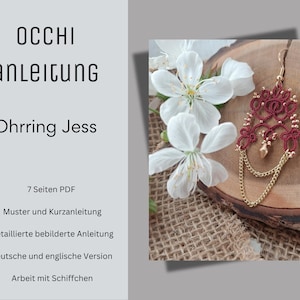 Könnte beinhalten: Nahaufnahme eines rot-goldenen Ohrrings mit floralem Design, der auf einer Holzoberfläche neben weißen Blüten liegt. Der Ohrring hat eine Tropfenkette und einen goldenen Haken. Der Text lautet "OCCHI anleitung Ohrring Jess".