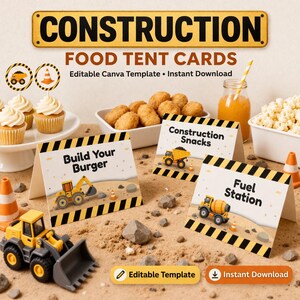 May include: Construction-themed food tent cards with text including "Build Your Burger", "Construction Snacks", and "Fuel Station". The cards feature illustrations of construction vehicles. The image also includes cupcakes, snacks, and a toy construction vehicle.