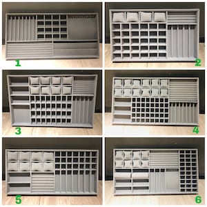 May include: Six different styles of gray jewelry organizers with compartments for rings, earrings, bracelets, and necklaces. Each organizer has a different configuration of compartments and slots.