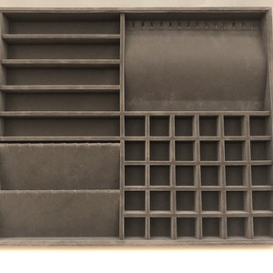 May include: A brown velvet jewelry organizer with multiple compartments for storing necklaces, earrings, rings, and bracelets. The organizer has a section with slots for hanging necklaces, a section with small squares for rings, and a section with shelves for bracelets.