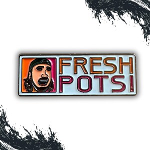 May include: A white enamel pin with a cartoon illustration of a person with a surprised expression. The text "FRESH POTS!" is written in orange and pink letters.